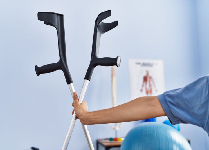 Someone holding a set of crutches