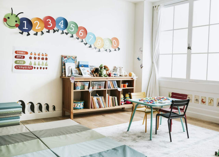 A toddler classroom with stickers on the wall and a warm ambiance