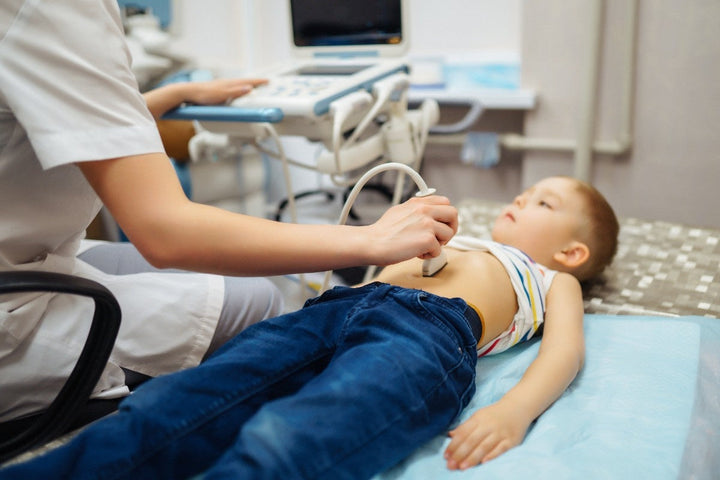 Boy undergoing thyroid ultrasound examination. 